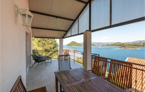 a balcony with a table and a view of the water at Lovely Home In Blace With Sauna in Blace