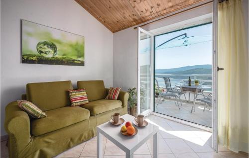 a living room with a couch and a table at Amazing Apartment In Rabac With Kitchen in Rabac