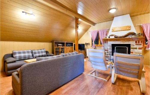 a living room with a couch and a fireplace at Lovely Home In Dreznica With Sauna in Jagetići
