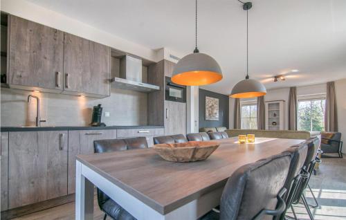 a kitchen with a large wooden table and chairs at Gorgeous Home In Den Ham With Sauna in Den Ham
