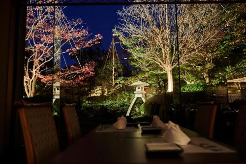 a table in a restaurant with a view of a boat at ANA Crowne Plaza Kanazawa by IHG in Kanazawa