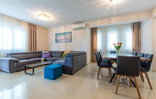 a living room with a couch and a table at Gorgeous Home In Dicmo With Sauna in Vojkovići