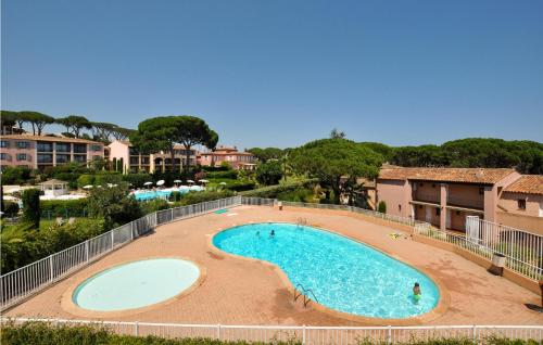 a large swimming pool in the middle of a resort at Amazing Apartment In Sainte-Maxime in Sainte-Maxime