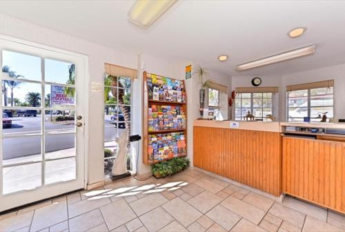 a kitchen with a refrigerator filled with drinks at Americas Best Value Inn San Clemente Beach in San Clemente