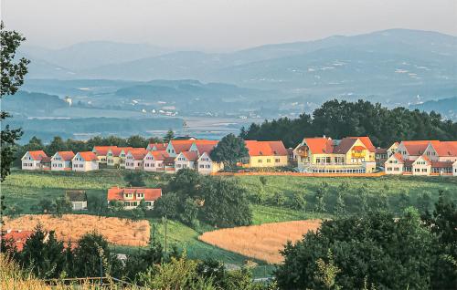 a group of houses on a hill with mountains in the background at Biodorf Bad Waltersdorf in Bad Waltersdorf
