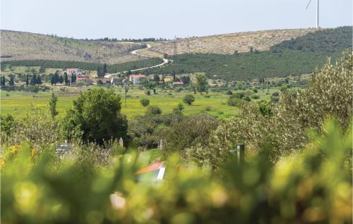 a view of a field with trees and a road at One-Bedroom Holiday Home In Danilo in Danilo Biranj