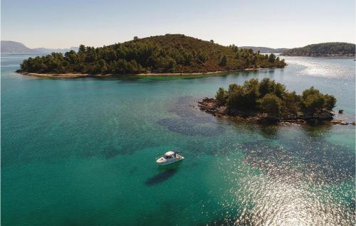 an island in the water with a boat in it at Holiday Home Zuljana - 08 in Žuljana