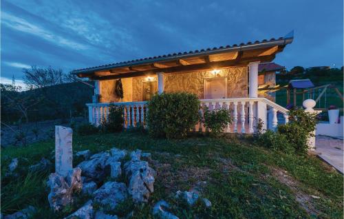 a small house with a porch and a fence at One-Bedroom Holiday Home In Danilo in Danilo Biranj