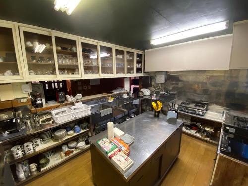an overhead view of a large kitchen with a counter at ロッヂノエル in Seki
