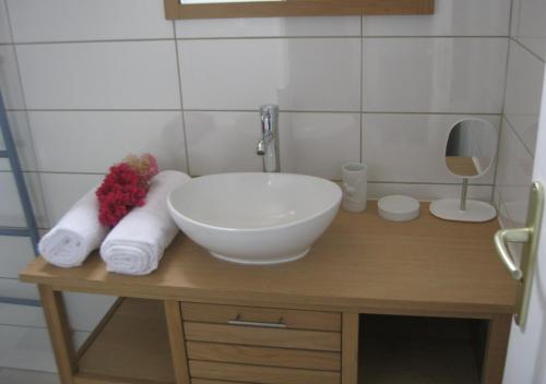 a bathroom with a sink and towels on a table at LAPALOMADESANSEs2 in Les Anses-dʼArlets
