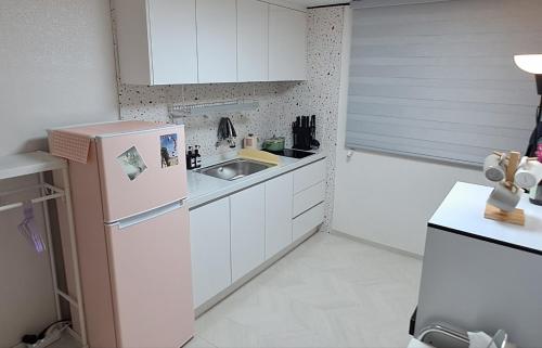 a small kitchen with a sink and a refrigerator at Warm Place in Seoul
