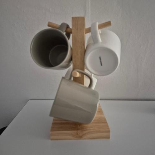 a coffee pot and a cup on a wooden stand at Warm Place in Seoul