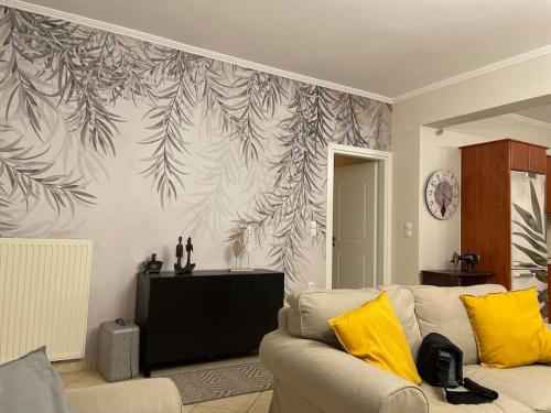 a living room with a couch and a wall mural at Althéa in Ambelákion