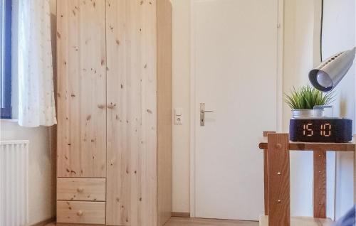 a room with a wooden door with a clock next to it at Holiday Home Gunderath With Fireplace I in Gunderath