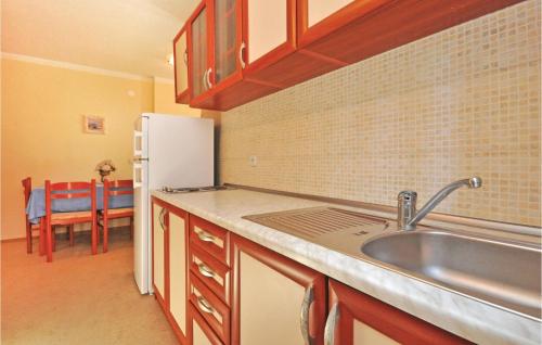 a kitchen with a sink and a refrigerator at Apartment Mimice With Sea View 382 in Mimice