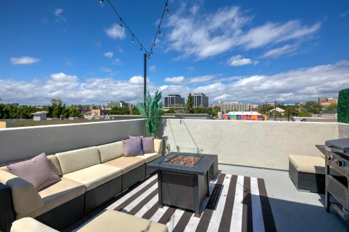 a patio with a couch and a table on a roof at La Veranda View Hideaway in Los Angeles
