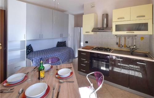 a kitchen with a wooden table with plates on it at Stunning Apartment In Lamezia Terme in Lamezia Terme