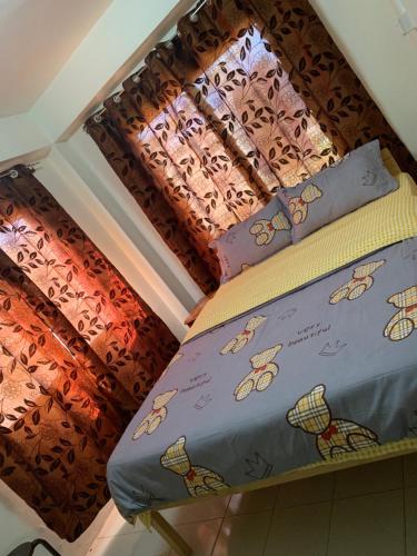 a bed with two pillows on top of it at Nadi Airport rooms in Nadi