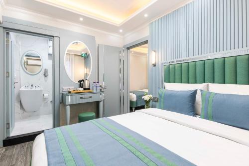 a hotel room with a bed and a bathroom at Santa Rio Gold Taxim Hotel in Istanbul