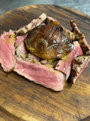 a piece of meat on a wooden cutting board at LOCANDA PODERE LE VIGNE in Radda in Chianti