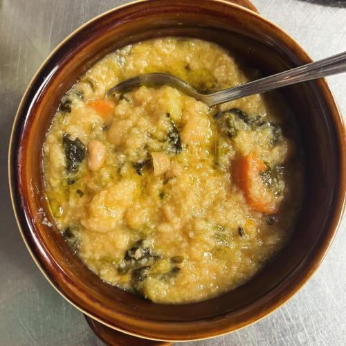 a bowl of soup with a spoon in it at LOCANDA PODERE LE VIGNE in Radda in Chianti
