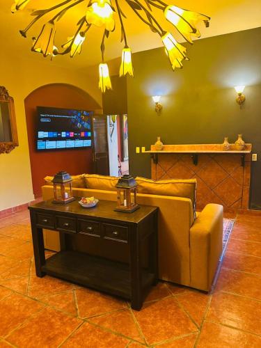 a living room with a couch and a table at Casa de Leyendas in Mazatlán