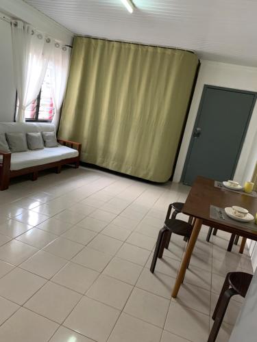 a living room with a couch and a table at Nadi Airport rooms in Nadi