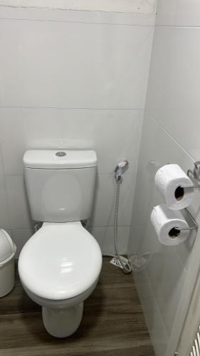 a bathroom with a toilet and two rolls of toilet paper at Suíte Recanto da Serra in Miguel Pereira