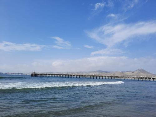 a pier in the middle of the ocean at Bungalows Cerro Azul in Cerro Azul