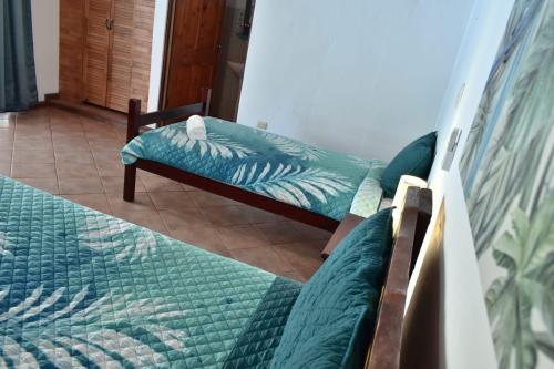 a living room with two beds and a couch at Hotel Planeta Sano in Manuel Antonio