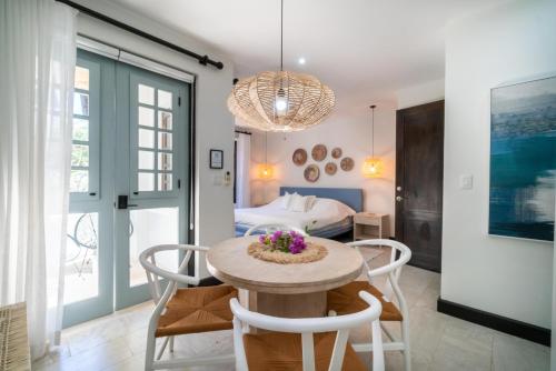 a room with a table and chairs and a bed at Calle La Ronda 18 At Las Catalinas in Playa Danta