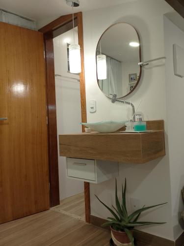 a bathroom with a sink and a mirror at Casa Duplex Condomínio Ipanema no Peró in Cabo Frio