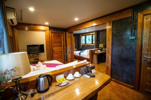 a room with a bed and a table with a lamp at Andalay Beach Resort Koh Libong in Ko Libong