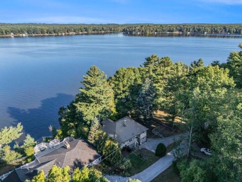 an overhead view of a house on the shore of a lake at Birch Tree Landing on Hamlin Lake in Ludington