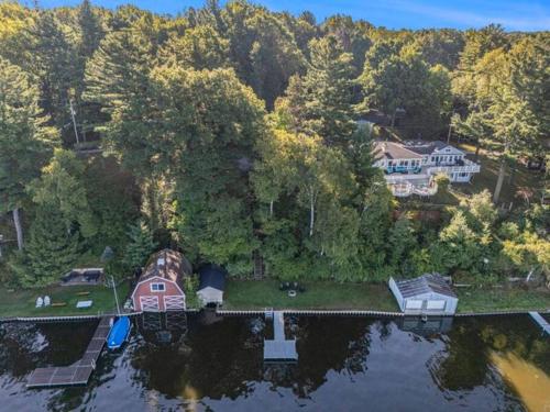 an aerial view of a house on a lake at Birch Tree Landing on Hamlin Lake in Ludington