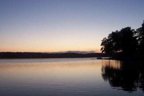 a view of a lake at sunset at Birch Tree Landing on Hamlin Lake in Ludington