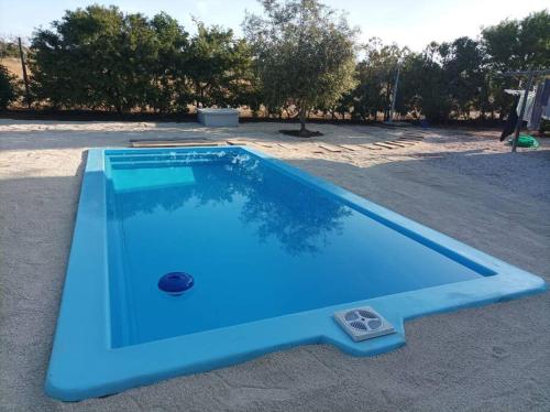 a blue swimming pool sitting on the ground at Exclusiva casa con vista panorámica al mar in Guanaqueros