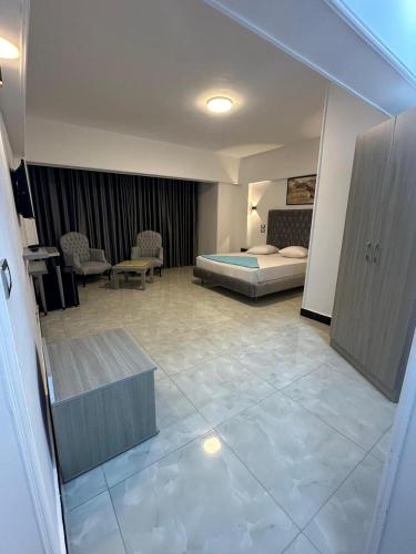 a hotel room with a bed and a large tile floor at Aura Inn Hotel Cairo in Cairo