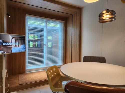 a dining room with a table and a window at Danyang Ondal and Pyeonggang Pension in Danyang