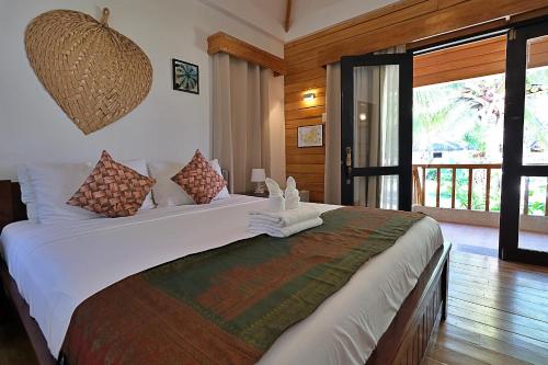 a bedroom with a large bed in a room at White Villas Resort in Siquijor