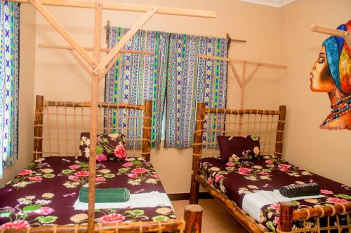 a bedroom with two bunk beds and a bedskirts at Palm Tree Villa Nungwi in Nungwi