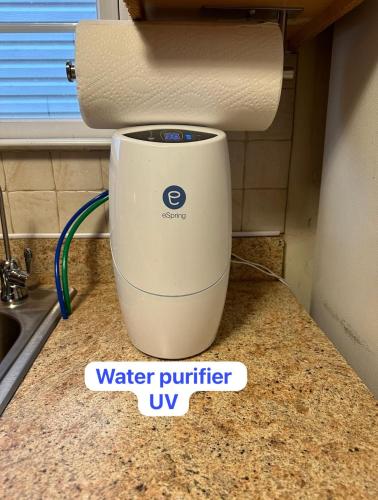 a water purifier sitting on a counter next to a sink at Pipo’s perfect place in Jersey City