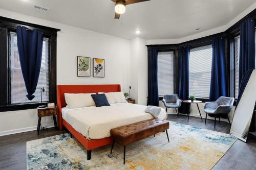 a bedroom with a large bed and some windows at Cates New Large Family Vacation Home Hot Tub Games Pets in Saint Louis