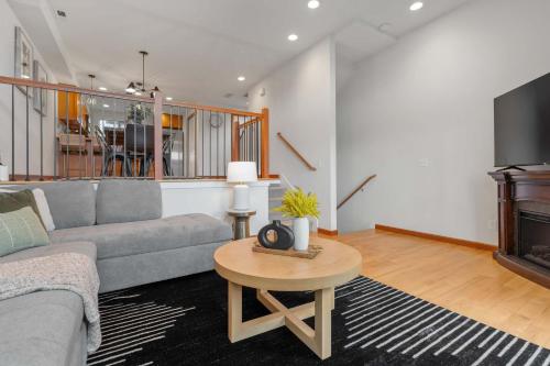 a living room with a couch and a tv and a table at LakeView Queen Anne 3BR Townhome in Seattle