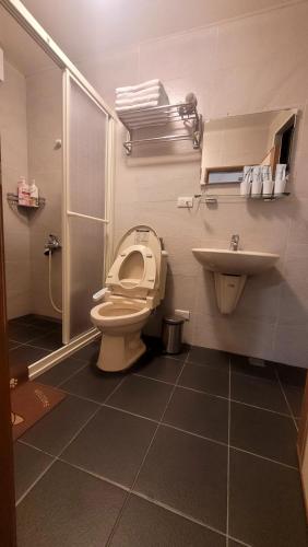 a bathroom with a toilet and a sink at 九份輕旅民宿 in Jiufen