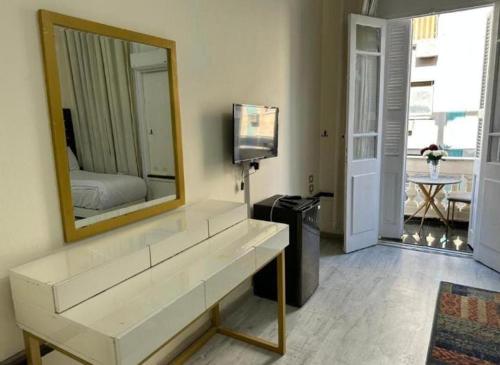 a living room with a large mirror and a tv at New Palace in Cairo