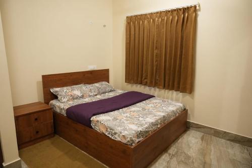 a bedroom with a bed and a window at The Great Escape at Yercaud in Yercaud