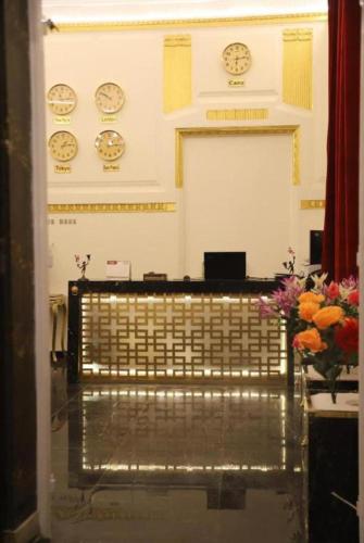 a room with clocks on the wall and a bench at New Palace in Cairo