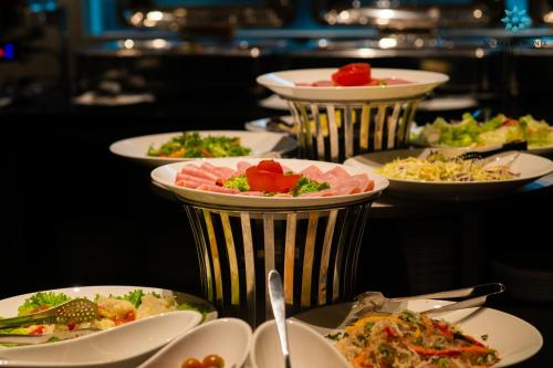a bunch of plates of food on a table at Solare De Monte Hotel & Spa in Hanoi