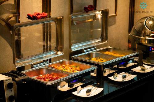three trays of food on a counter in a kitchen at Solare De Monte Hotel & Spa in Hanoi